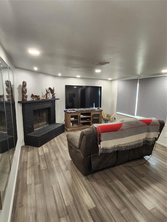 living room with hardwood / wood-style floors and a fireplace