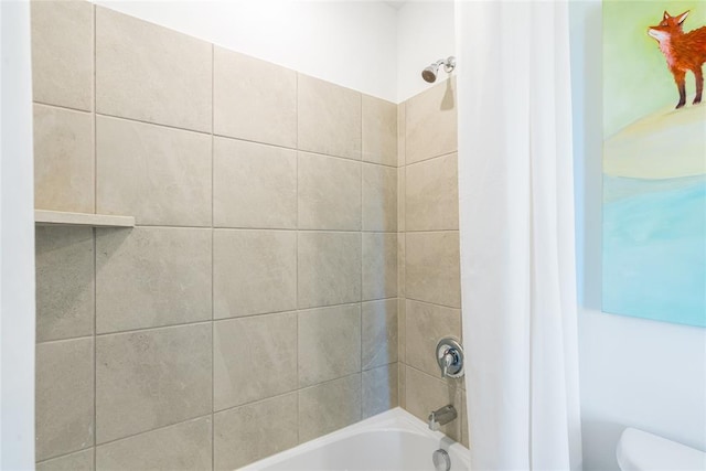 bathroom with toilet and shower / bath combo with shower curtain