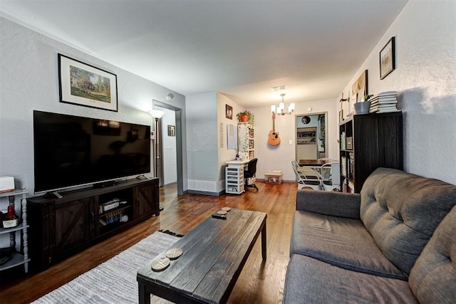 living room featuring dark hardwood / wood-style floors and a notable chandelier