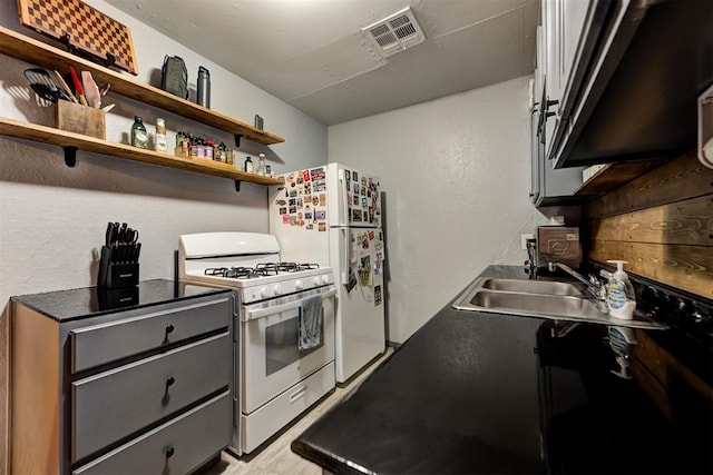 kitchen with sink and white gas stove