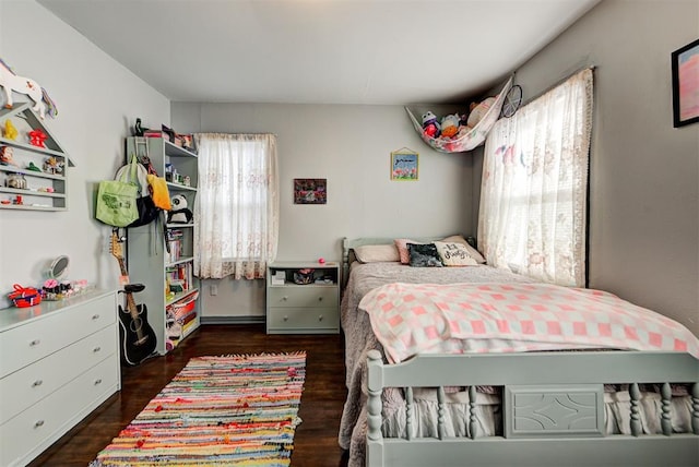 bedroom with dark hardwood / wood-style floors