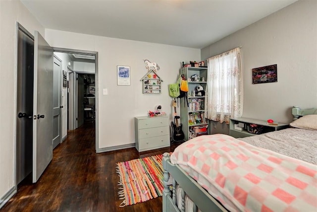 bedroom with dark hardwood / wood-style flooring