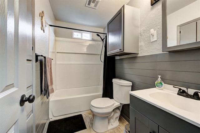 full bathroom featuring shower / bath combination with curtain, vanity, and toilet