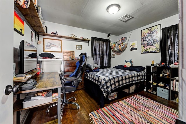 bedroom featuring dark hardwood / wood-style flooring