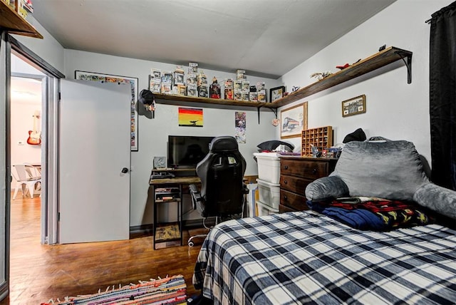 bedroom with hardwood / wood-style flooring