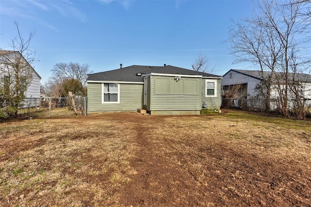 back of house with a lawn