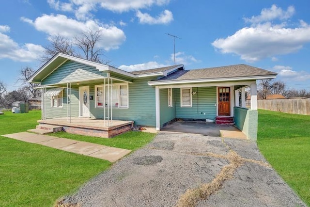 view of front of house featuring a front yard and covered porch