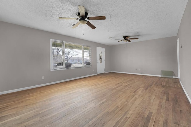 unfurnished room featuring ceiling fan, a textured ceiling, and light hardwood / wood-style flooring