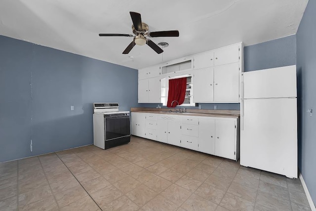 kitchen featuring sink, ceiling fan, electric range oven, white cabinets, and white fridge