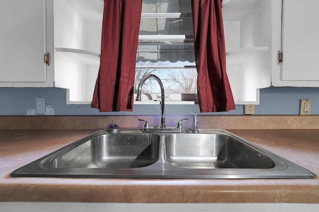 kitchen with white cabinetry and sink