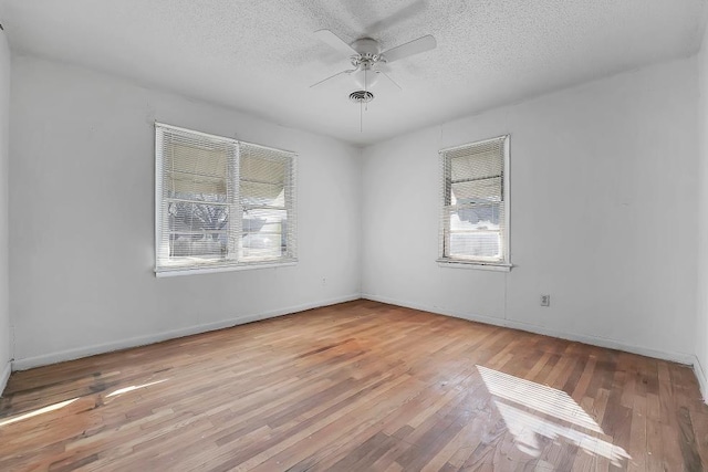 spare room featuring ceiling fan, a textured ceiling, and light wood-type flooring