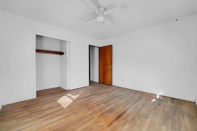 unfurnished bedroom with light hardwood / wood-style floors, a closet, and ceiling fan