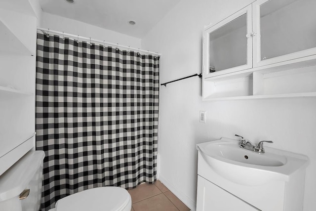 bathroom with tile patterned flooring, vanity, and toilet