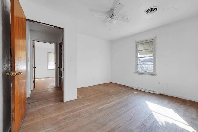 unfurnished room featuring ceiling fan, plenty of natural light, and light wood-type flooring