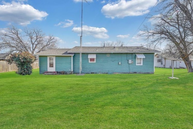 back of house featuring a lawn