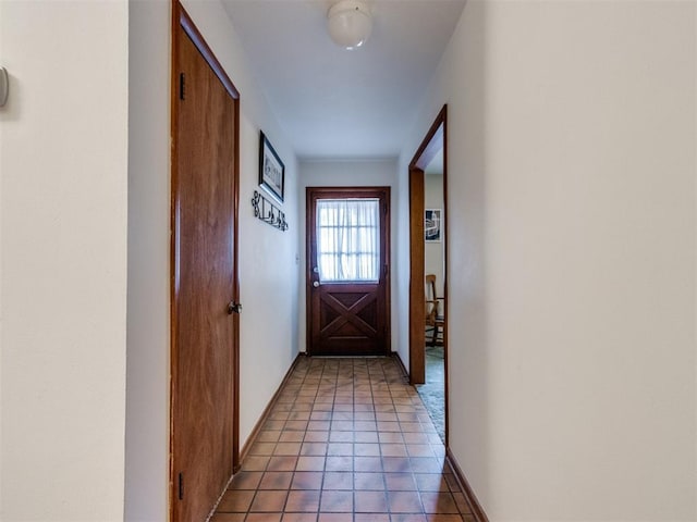 doorway to outside with tile patterned flooring