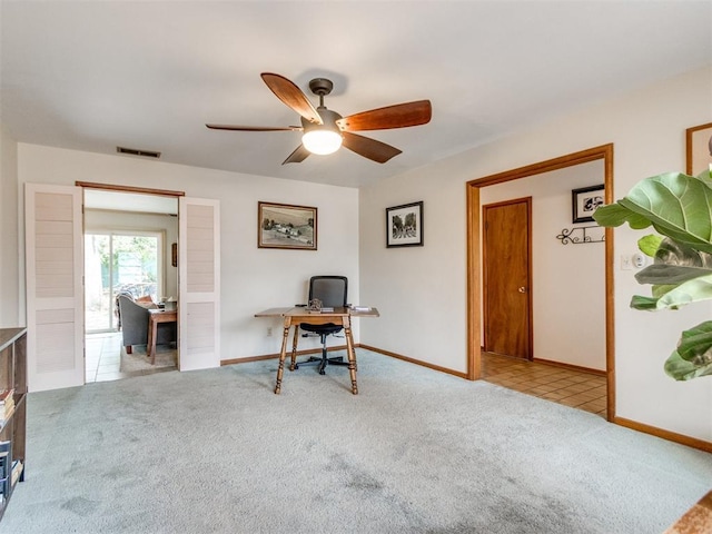 interior space with light colored carpet and ceiling fan