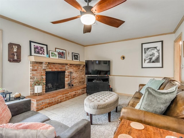 living room with ceiling fan, ornamental molding, a fireplace, and light tile patterned floors