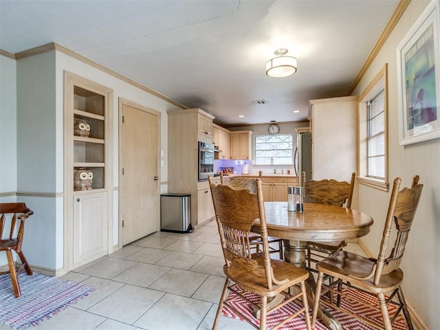 tiled dining space with crown molding and built in features