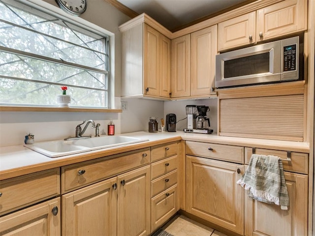 kitchen featuring light tile patterned flooring, sink, and light brown cabinets