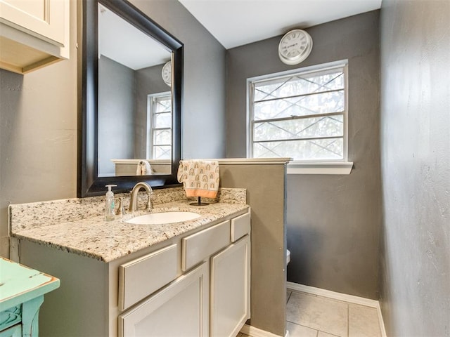 bathroom with tile patterned flooring, vanity, and a wealth of natural light