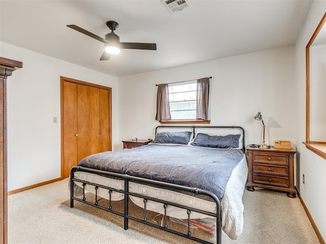 carpeted bedroom featuring a closet and ceiling fan