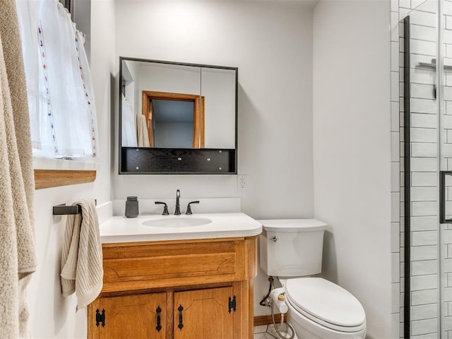 bathroom featuring walk in shower, vanity, and toilet