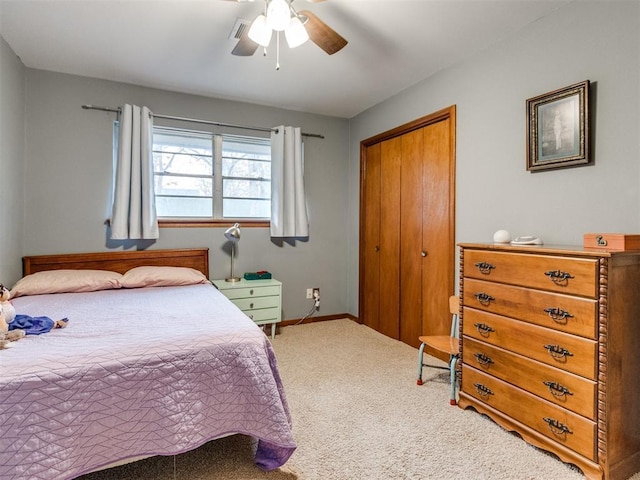 carpeted bedroom with a closet and ceiling fan