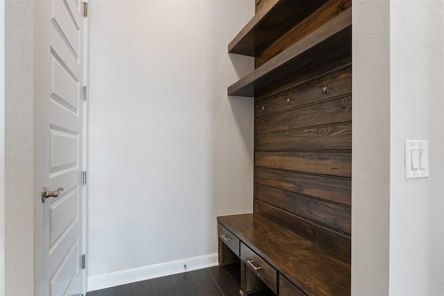 mudroom featuring baseboards and dark wood-style flooring