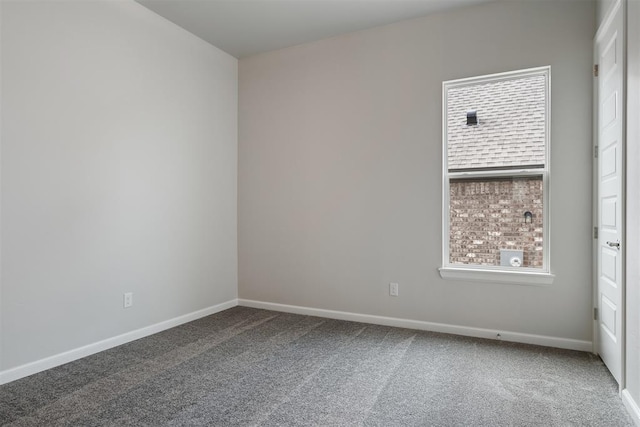 empty room featuring plenty of natural light, carpet flooring, and baseboards