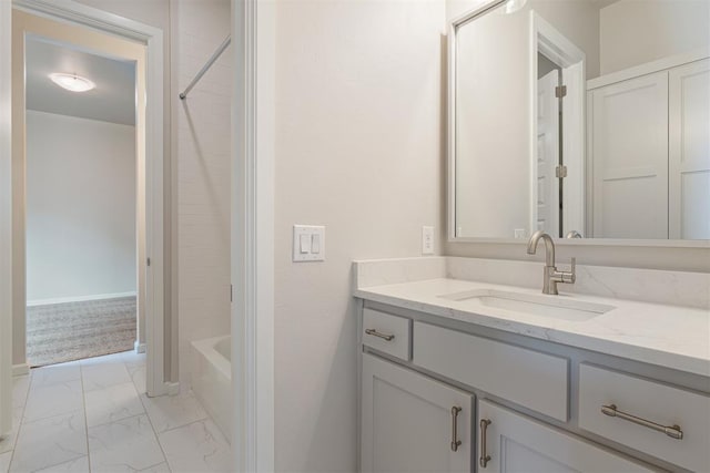 full bathroom featuring shower / bath combination, marble finish floor, baseboards, and vanity