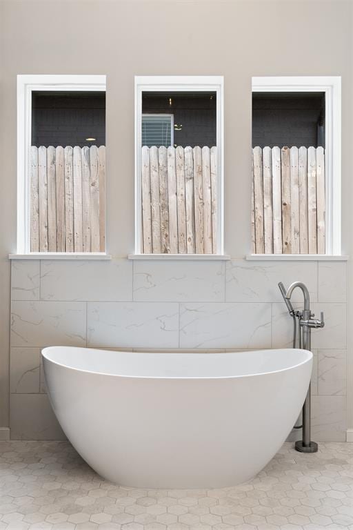 full bath featuring a soaking tub