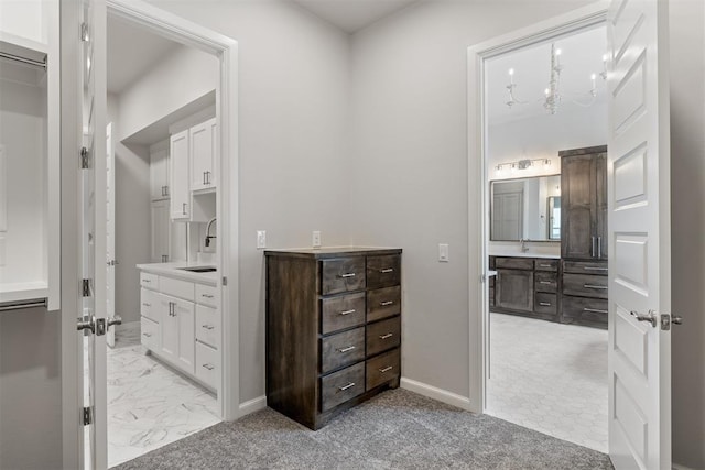 bathroom featuring marble finish floor, baseboards, and vanity