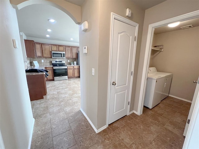 washroom featuring washer and clothes dryer and sink