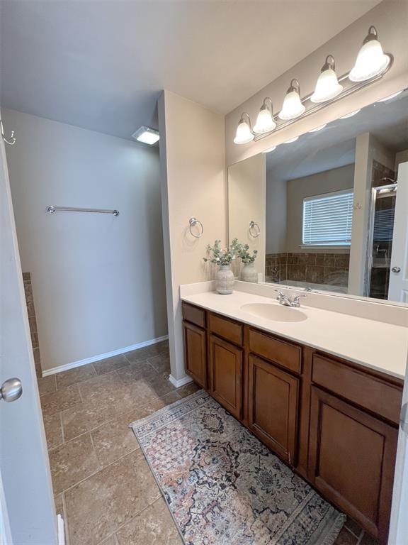 bathroom with vanity and a shower with shower door