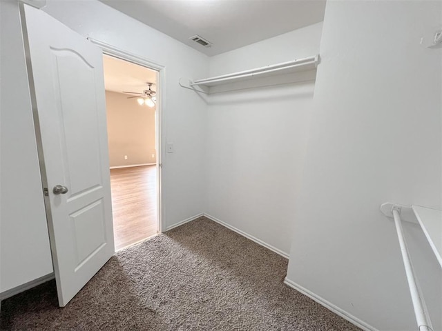 spacious closet with dark carpet