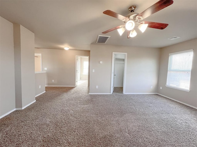 empty room with carpet flooring and ceiling fan