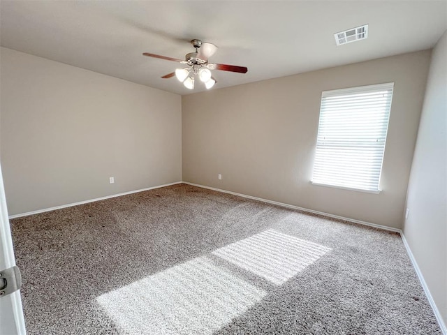 carpeted spare room with ceiling fan