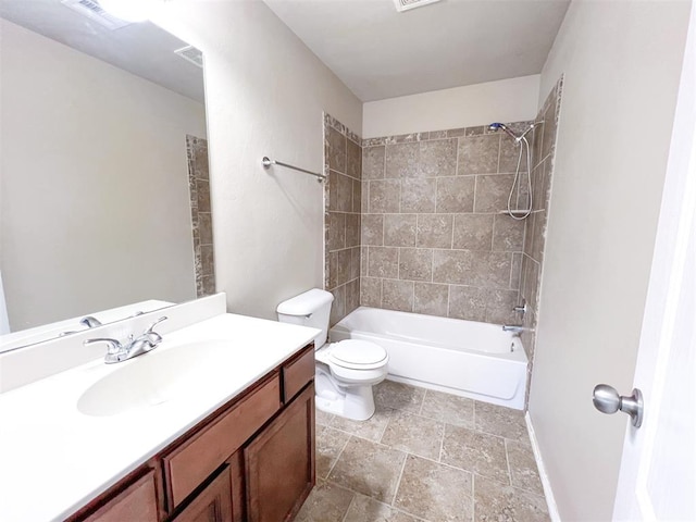 full bathroom with tiled shower / bath, vanity, and toilet