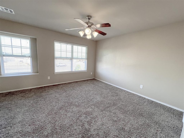 carpeted spare room with ceiling fan