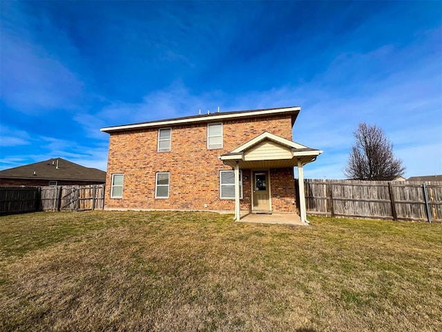 back of property with a patio and a lawn