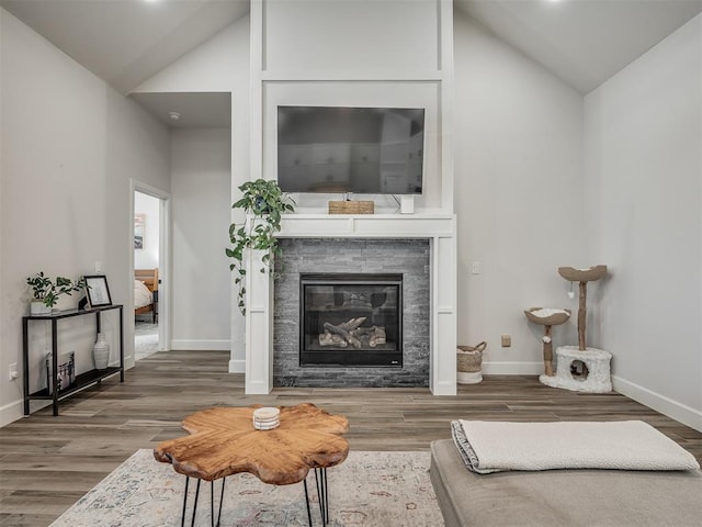 living room featuring lofted ceiling and dark hardwood / wood-style flooring