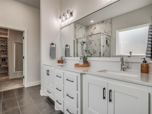 bathroom featuring vanity, tile patterned floors, and walk in shower