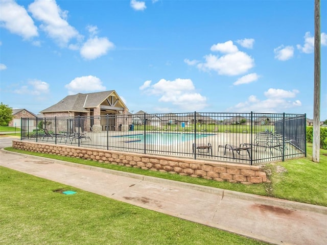 view of pool with a patio area and a lawn