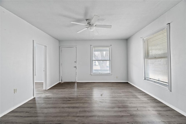 unfurnished room featuring dark hardwood / wood-style floors and ceiling fan