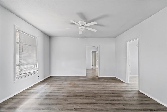 unfurnished room featuring ceiling fan and dark hardwood / wood-style flooring