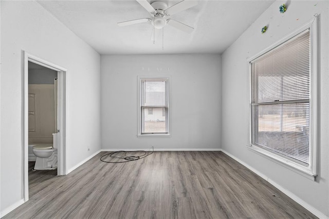 empty room with light hardwood / wood-style flooring and ceiling fan