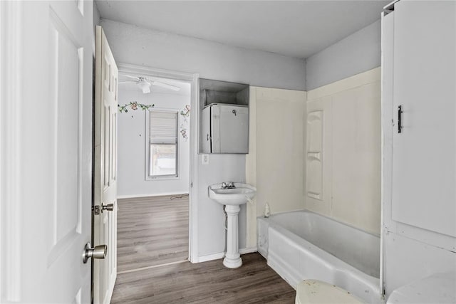 bathroom with shower / bathing tub combination and hardwood / wood-style floors