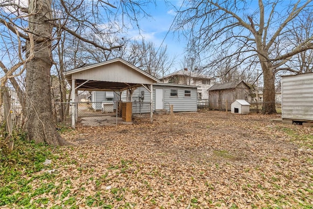 rear view of property featuring a storage shed