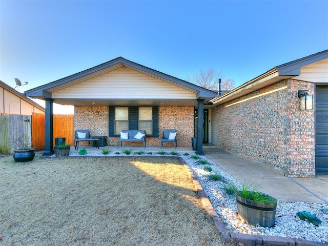 rear view of house featuring a lawn and a patio